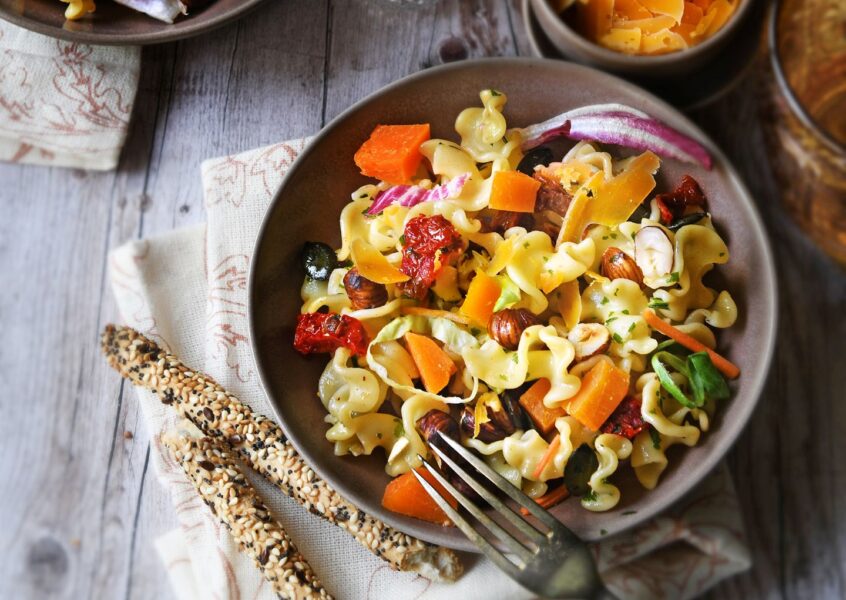 Salade de pâtes, mimolette, tomates séchées & éclats de noisettes